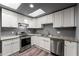 Updated kitchen with stainless appliances, white cabinets, hardwood floors, and granite countertops at 2991 Black Bear Se Dr, Marietta, GA 30067