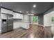 A modern kitchen featuring stainless steel appliances, white cabinets, and hardwood floors at 2991 Black Bear Se Dr, Marietta, GA 30067