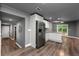 Spacious kitchen with stainless steel refrigerator, white cabinets, and hardwood floors leading to backyard access at 2991 Black Bear Se Dr, Marietta, GA 30067