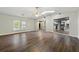 Open-concept living room with hardwood floors, fan, and great natural light, flowing into kitchen at 2991 Black Bear Se Dr, Marietta, GA 30067