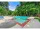 Community pool featuring a lounge area and mature trees at 2991 Black Bear Se Dr, Marietta, GA 30067