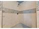 Close-up of walk-in shower with tiled walls and stone accents at 2991 Black Bear Se Dr, Marietta, GA 30067