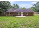 Brick home exterior and a well-maintained lawn create a perfect backyard at 35 Riverbend Dr, Covington, GA 30014