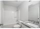 Bright bathroom features granite vanity, toilet, bathtub and tiled shower with grab bar at 35 Riverbend Dr, Covington, GA 30014