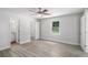 Comfortable bedroom featuring gray wood-look floors, closet, and bathroom access at 35 Riverbend Dr, Covington, GA 30014