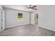 Sunlit bedroom with light gray walls, carpet, a ceiling fan and a view to the backyard at 35 Riverbend Dr, Covington, GA 30014