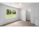 Bedroom with bright natural light and view to the back, closet and ceiling fan at 35 Riverbend Dr, Covington, GA 30014