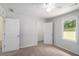 Neutral bedroom featuring a ceiling fan and natural light from the window overlooking the greenery outside at 35 Riverbend Dr, Covington, GA 30014