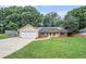 Charming single-story home with an attached garage, solar panels, and a well-maintained front lawn at 35 Riverbend Dr, Covington, GA 30014