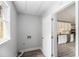 Hallway with a view of the renovated kitchen and sleek flooring adding brightness to the home at 35 Riverbend Dr, Covington, GA 30014
