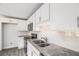 Updated kitchen featuring new gray vinyl floors, granite countertops, white cabinets, and stainless steel appliances at 35 Riverbend Dr, Covington, GA 30014