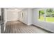 Inviting living space featuring modern gray flooring, fresh white walls, and ample natural light from large windows at 35 Riverbend Dr, Covington, GA 30014