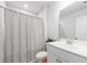 Bright bathroom with a white vanity, large mirror and shower with a neutral patterned curtain at 807 Parker Pass, Peachtree City, GA 30269