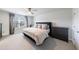 Spacious bedroom with a queen bed, dark dressers, and neutral decor at 807 Parker Pass, Peachtree City, GA 30269