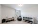 Bedroom room with chair, crib, and decor-friendly shelving unit at 807 Parker Pass, Peachtree City, GA 30269