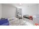 Bedroom room with white crib, chair, and geometric patterned rug at 807 Parker Pass, Peachtree City, GA 30269