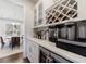 Elegant butler's pantry with wine storage, beverage fridge and quartz countertop at 807 Parker Pass, Peachtree City, GA 30269