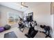 Home exercise room with ceiling fan, large window, and a variety of workout equipment at 807 Parker Pass, Peachtree City, GA 30269