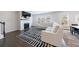 Bright living room features a fireplace, large windows, and a stylish black-and-white patterned rug at 807 Parker Pass, Peachtree City, GA 30269