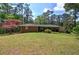 View of the rear exterior of the home, highlighting the large backyard with mature trees for privacy at 3156 Pope Rd, Douglasville, GA 30135