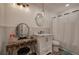 Charming bathroom featuring a vanity with round mirror and shower with subway tile at 3156 Pope Rd, Douglasville, GA 30135
