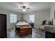 Cozy bedroom features natural light from two windows, wood-look floors and a ceiling fan at 3156 Pope Rd, Douglasville, GA 30135