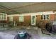 This covered patio features a dining set, plants, and brick accents creating an inviting outdoor space at 3156 Pope Rd, Douglasville, GA 30135