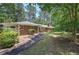 Charming brick home featuring a walkway lined with manicured bushes at 3156 Pope Rd, Douglasville, GA 30135