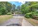 Charming single story home nestled among mature trees with a long driveway offering ample parking at 3156 Pope Rd, Douglasville, GA 30135