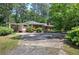 Traditional home with brick facade, complemented by a covered carport and mature landscaping at 3156 Pope Rd, Douglasville, GA 30135