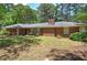 Classic brick home with a traditional design and well-maintained front lawn and bushes at 3156 Pope Rd, Douglasville, GA 30135