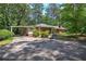 Traditional home with brick facade, complemented by a covered carport and mature landscaping at 3156 Pope Rd, Douglasville, GA 30135