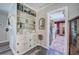 Well-lit hallway with built-in shelving and storage, leading to the kitchen at 3156 Pope Rd, Douglasville, GA 30135