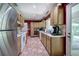 Cozy kitchen with brick floors, oak cabinets, and stainless steel refrigerator at 3156 Pope Rd, Douglasville, GA 30135