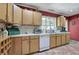 Well-lit kitchen with oak cabinetry, white appliances, and a vintage bread box at 3156 Pope Rd, Douglasville, GA 30135