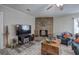 Cozy living room boasts a unique brick fireplace, a ceiling fan, and stylish flooring at 3156 Pope Rd, Douglasville, GA 30135