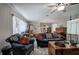 Bright and airy living room with beautiful furniture, a ceiling fan, and great flooring at 3156 Pope Rd, Douglasville, GA 30135
