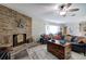 Charming living room with a brick fireplace, ceiling fan, and stylish flooring at 3156 Pope Rd, Douglasville, GA 30135