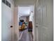View from entryway into the living room featuring hardwood floors, brick fireplace, and a ceiling fan at 3156 Pope Rd, Douglasville, GA 30135