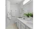 Bright bathroom features double sinks, white cabinets, and neutral tile flooring at 3754 Berkeley Xing, Duluth, GA 30096