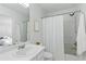 The bright bathroom features a shower and tub combo, sink, and decorative seashell at 3754 Berkeley Xing, Duluth, GA 30096