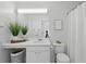 Bright bathroom features vanity, sink, decorative plants, and modern toilet at 3754 Berkeley Xing, Duluth, GA 30096