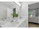 Bright bathroom with double sinks and an adjacent bedroom visible at 3754 Berkeley Xing, Duluth, GA 30096