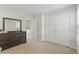 Bedroom featuring double closet, large dresser and neutral color palette at 3754 Berkeley Xing, Duluth, GA 30096