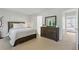 This neutral bedroom features a large dresser, windows, and view into the bathroom at 3754 Berkeley Xing, Duluth, GA 30096