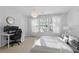 Bright bedroom features a large window, a desk, and a comfortable bed at 3754 Berkeley Xing, Duluth, GA 30096