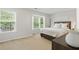 Bright bedroom features large windows, neutral color palette, and cozy carpet at 3754 Berkeley Xing, Duluth, GA 30096