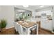 Bright dining area connected to a modern kitchen and living room at 3754 Berkeley Xing, Duluth, GA 30096