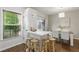 Light-filled dining area boasts a modern chandelier, a breakfast bar, and hardwood floors at 3754 Berkeley Xing, Duluth, GA 30096