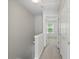 Upstairs hallway features neutral paint, carpeting, and doors to bedrooms and storage at 3754 Berkeley Xing, Duluth, GA 30096